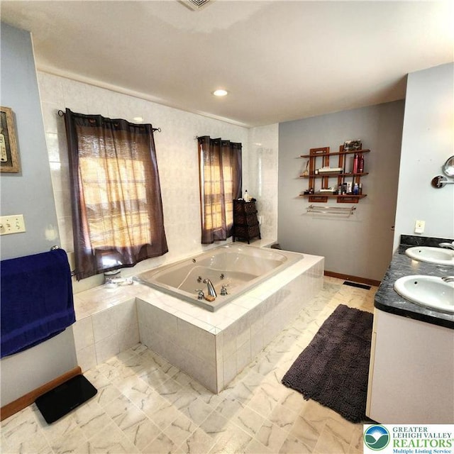 408 Sassafrass Way, Jackson Twp, PA 18360 - bathroom with a tub with jets, double vanity, and marble look tiles