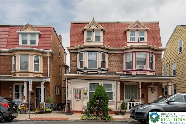 14 S 14th St, Easton, PA 18042 - victorian-style house featuring mansard roof, a porch, brick siding, and cooling unit
