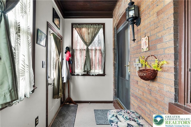 14 S 14th St, Easton, PA 18042 - doorway featuring wooden ceiling, carpet, and brick wall