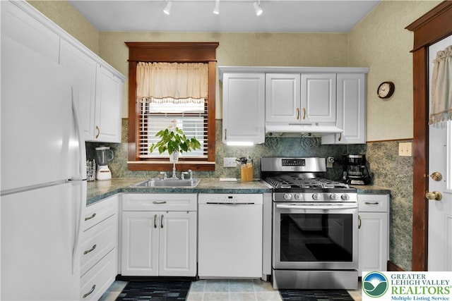 14 S 14th St, Easton, PA 18042 - kitchen featuring white appliances, under cabinet range hood, white cabinets, track lighting, and dark countertops