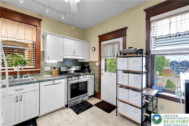 14 S 14th St, Easton, PA 18042 - kitchen with white dishwasher, gas stove, under cabinet range hood, and plenty of natural light