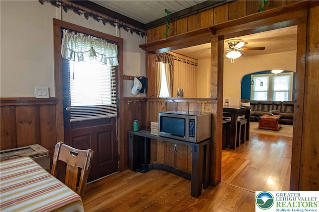 1666 Newport Ave, Northampton Boro, PA 18067 - dining room featuring a wainscoted wall, wood finished floors, arched walkways, a ceiling fan, and wood walls