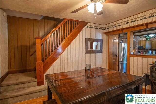 1666 Newport Ave, Northampton Boro, PA 18067 - dining area with stairway, a ceiling fan, and wooden walls