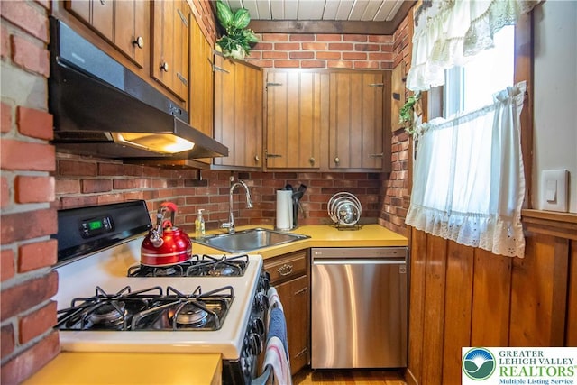 1666 Newport Ave, Northampton Boro, PA 18067 - kitchen featuring gas range, stainless steel dishwasher, under cabinet range hood, light countertops, and brown cabinetry