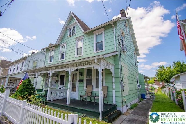1666 Newport Ave, Northampton Boro, PA 18067 - victorian house with covered porch, a chimney, and a fenced front yard