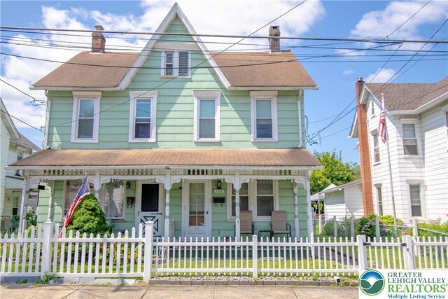 1666 Newport Ave, Northampton Boro, PA 18067 - view of front of house with a porch, a chimney, a fenced front yard, and roof with shingles