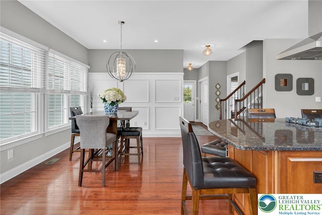 4508 Homestead Dr, Lower Nazareth Twp, PA 18064 - dining area featuring stairway, dark wood-style flooring, a chandelier, a decorative wall, and recessed lighting