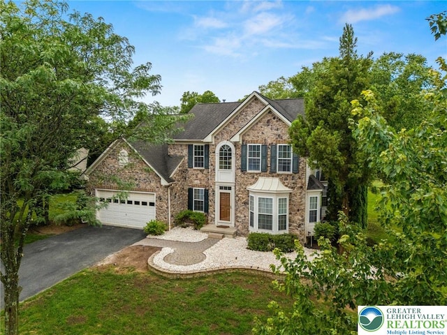 232 S 33rd St, South Whitehall Twp, PA 18104 - colonial home with stone siding, driveway, and a garage