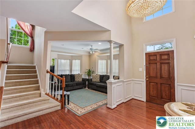 232 S 33rd St, South Whitehall Twp, PA 18104 - foyer featuring wood finished floors, ornate columns, stairway, ceiling fan, and a wainscoted wall