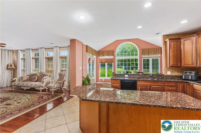 232 S 33rd St, South Whitehall Twp, PA 18104 - kitchen with black dishwasher, open floor plan, lofted ceiling, brown cabinets, and light tile patterned flooring