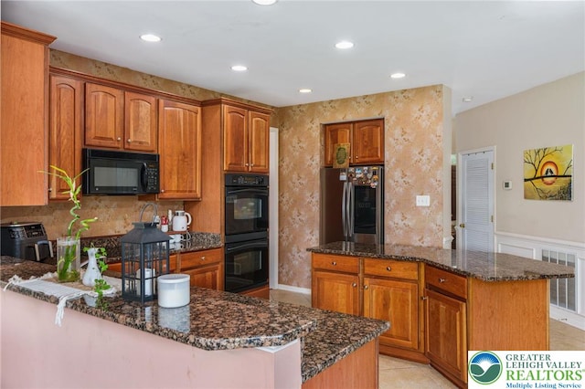 232 S 33rd St, South Whitehall Twp, PA 18104 - kitchen featuring black appliances, dark stone countertops, a peninsula, brown cabinets, and recessed lighting