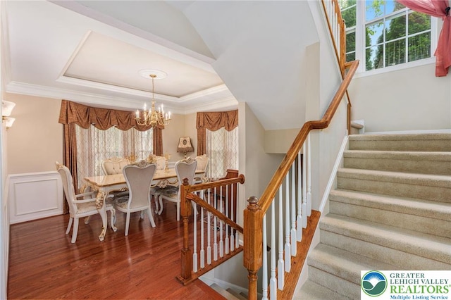 232 S 33rd St, South Whitehall Twp, PA 18104 - stairs with a chandelier, healthy amount of natural light, wood finished floors, a raised ceiling, and ornamental molding