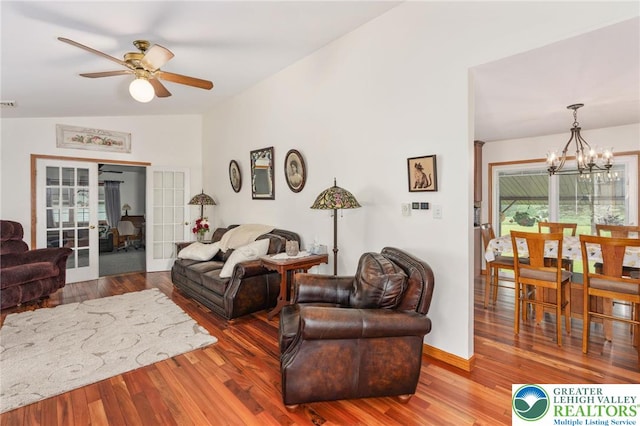 7438 Rte 309, Lynn Twp, PA 18066 - living room featuring a ceiling fan, vaulted ceiling, a chandelier, wood finished floors, and french doors