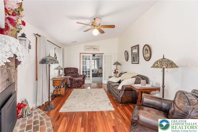 7438 Rte 309, Lynn Twp, PA 18066 - living room featuring vaulted ceiling, ceiling fan, wood finished floors, and a fireplace