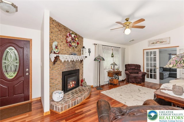 7438 Rte 309, Lynn Twp, PA 18066 - living area featuring wood finished floors, a ceiling fan, lofted ceiling, and a fireplace
