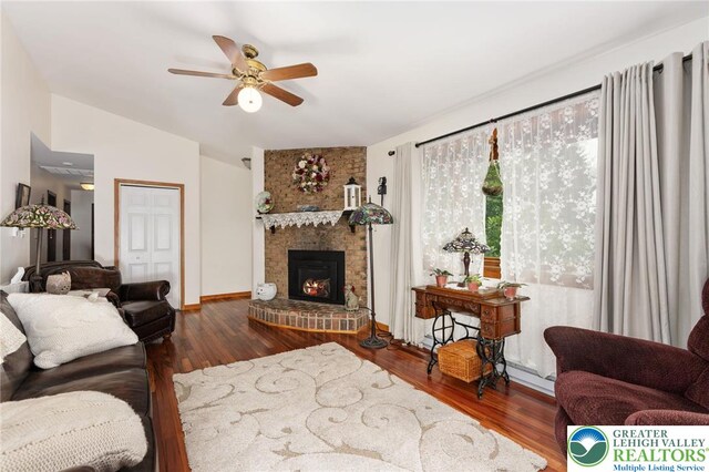 7438 Rte 309, Lynn Twp, PA 18066 - living room with lofted ceiling, a ceiling fan, wood finished floors, and a brick fireplace