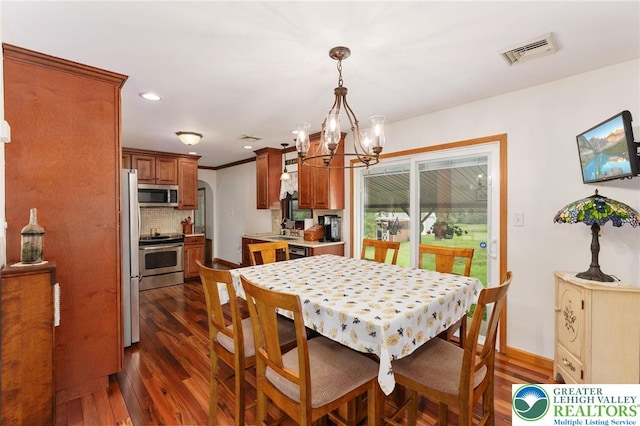 7438 Rte 309, Lynn Twp, PA 18066 - dining room featuring a chandelier, dark wood-type flooring, arched walkways, and recessed lighting