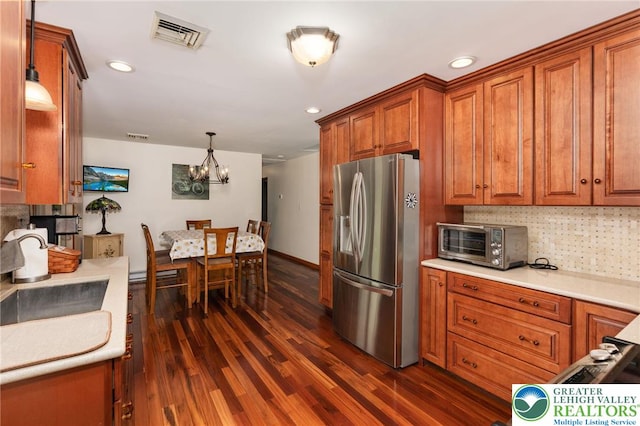7438 Rte 309, Lynn Twp, PA 18066 - kitchen with stainless steel refrigerator with ice dispenser, brown cabinets, dark wood-style floors, a chandelier, and light countertops