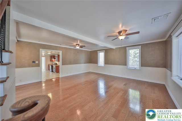 5758 Lower Macungie Rd, Lower Macungie Twp, PA 18062 - unfurnished living room featuring a ceiling fan, wood finished floors, a wainscoted wall, and beamed ceiling