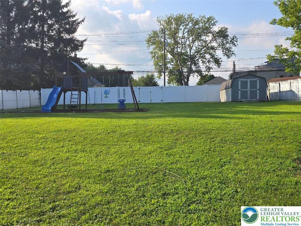 4017 Birch Dr, Bethlehem City, PA 18020 - fenced backyard with a shed and a playground