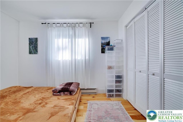 9379 Fairmount, Coolbaugh Twp, PA 18466 - bedroom with baseboard heating, light wood-type flooring, and a closet