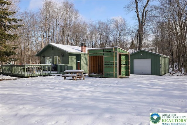 9379 Fairmount, Coolbaugh Twp, PA 18466 - view of front of home with a garage, a chimney, an outbuilding, and a deck