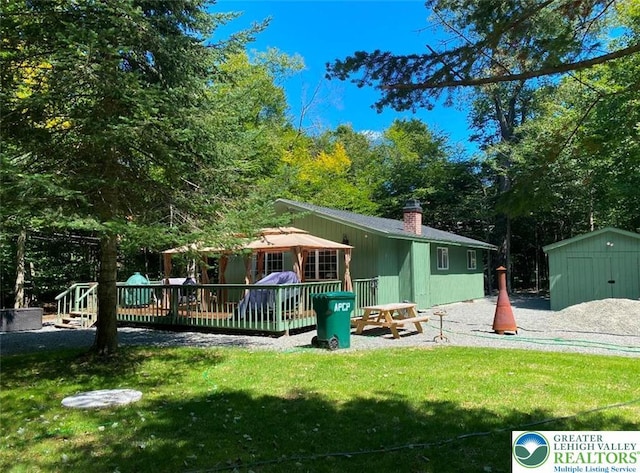 9379 Fairmount, Coolbaugh Twp, PA 18466 - back of house featuring a storage unit, a lawn, a deck, and a chimney