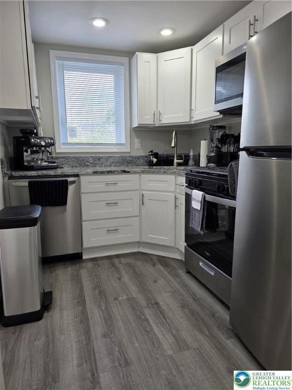 1523 Cedar St, Northampton Boro, PA 18067 - kitchen featuring appliances with stainless steel finishes, white cabinetry, light stone counters, dark wood-type flooring, and recessed lighting