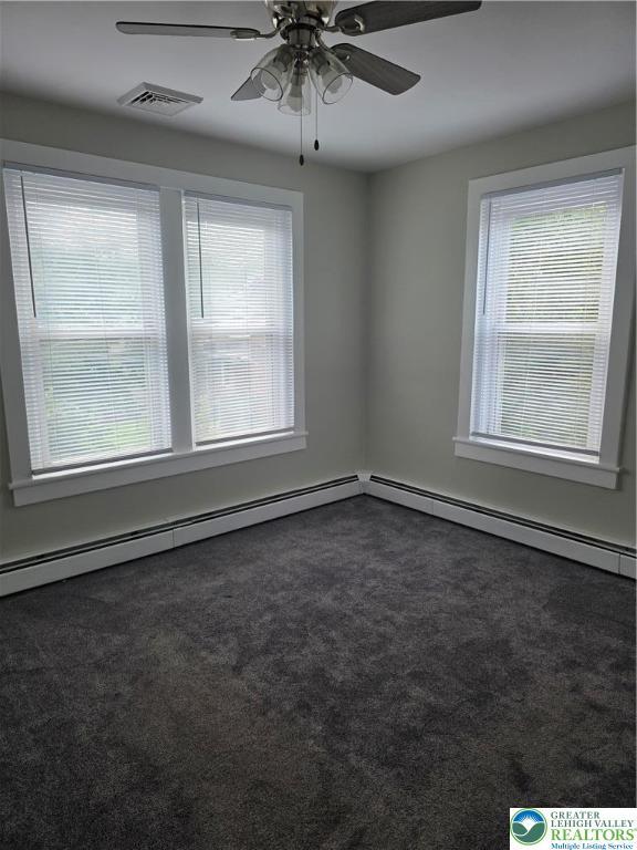 1523 Cedar St, Northampton Boro, PA 18067 - spare room with dark carpet, a ceiling fan, and a baseboard radiator