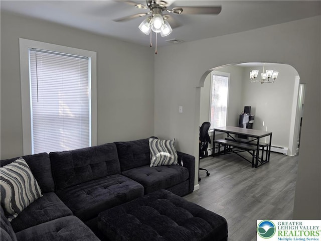 1523 Cedar St, Northampton Boro, PA 18067 - living area featuring arched walkways, a ceiling fan, wood finished floors, a chandelier, and a baseboard radiator