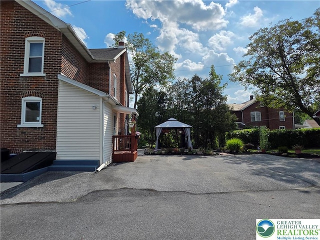 1523 Cedar St, Northampton Boro, PA 18067 - view of property exterior with a gazebo, brick siding, and a chimney