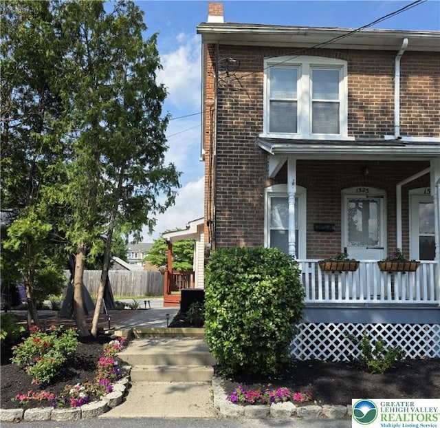 1523 Cedar St, Northampton Boro, PA 18067 - view of property exterior featuring brick siding, covered porch, and a chimney