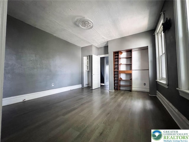 206 21st St, Northampton Boro, PA 18067 - unfurnished bedroom with dark wood-style flooring and a textured ceiling