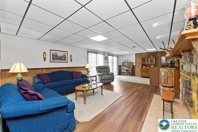 4661 Hillside Rd, Coplay Boro, PA 18037 - living area with wooden walls, a wainscoted wall, wood finished floors, and a paneled ceiling