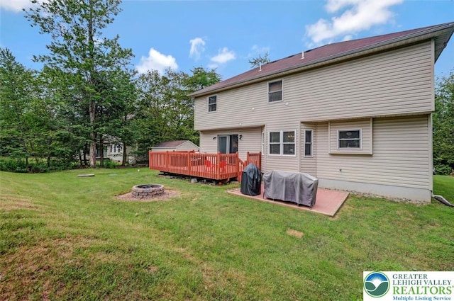5117 Hounds Ear Rd, Coolbaugh Twp, PA 18466 - rear view of house featuring an outdoor fire pit, a deck, and a lawn