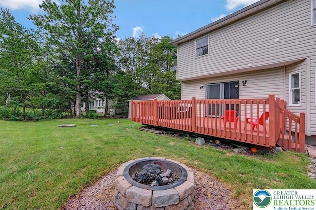 5117 Hounds Ear Rd, Coolbaugh Twp, PA 18466 - view of grassy yard with an outdoor fire pit and a deck