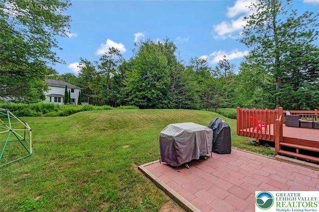 5117 Hounds Ear Rd, Coolbaugh Twp, PA 18466 - view of green lawn with a patio and a wooden deck
