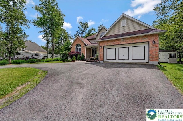 5117 Hounds Ear Rd, Coolbaugh Twp, PA 18466 - ranch-style house featuring asphalt driveway, brick siding, a garage, and a front lawn