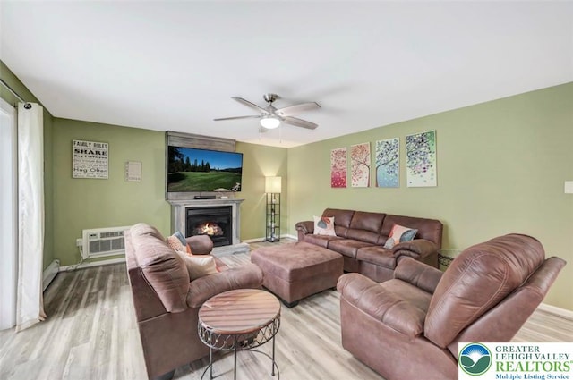5117 Hounds Ear Rd, Coolbaugh Twp, PA 18466 - living room featuring ceiling fan, wood finished floors, and a warm lit fireplace