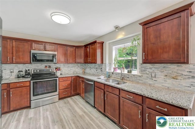 5117 Hounds Ear Rd, Coolbaugh Twp, PA 18466 - kitchen with appliances with stainless steel finishes, backsplash, and light stone counters
