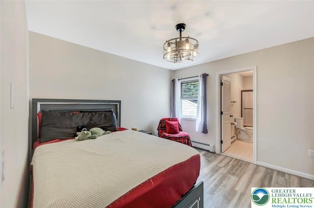 5117 Hounds Ear Rd, Coolbaugh Twp, PA 18466 - bedroom with baseboard heating, light wood-style flooring, a chandelier, and connected bathroom