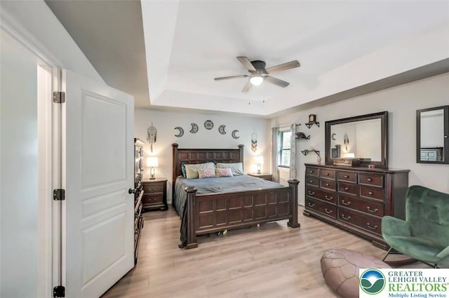 5117 Hounds Ear Rd, Coolbaugh Twp, PA 18466 - bedroom featuring a raised ceiling, light wood finished floors, and a ceiling fan