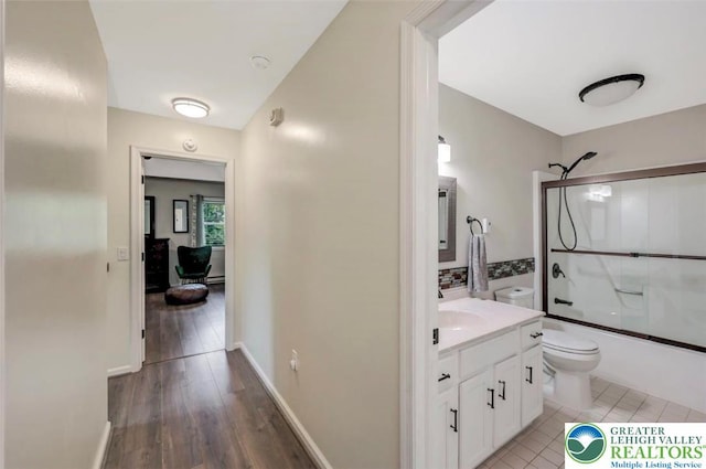 5117 Hounds Ear Rd, Coolbaugh Twp, PA 18466 - full bathroom featuring vanity, shower / bath combination with glass door, and wood finished floors