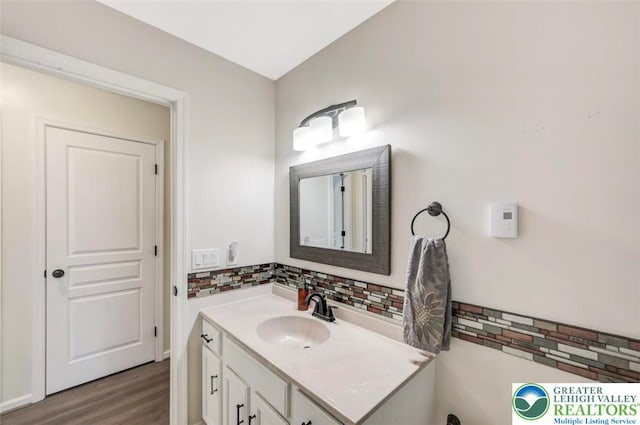 5117 Hounds Ear Rd, Coolbaugh Twp, PA 18466 - bathroom with tasteful backsplash, vanity, and wood finished floors