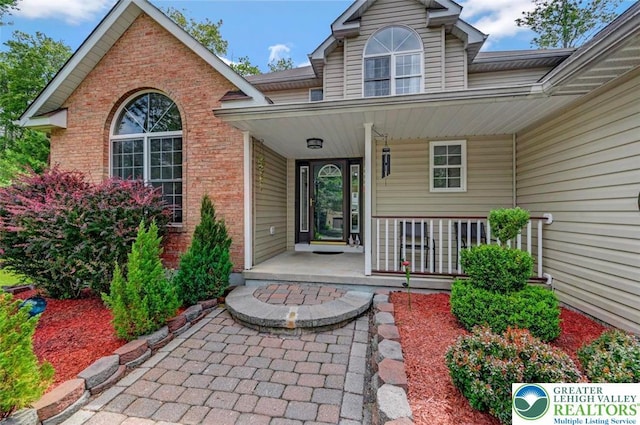 5117 Hounds Ear Rd, Coolbaugh Twp, PA 18466 - entrance to property featuring brick siding and covered porch