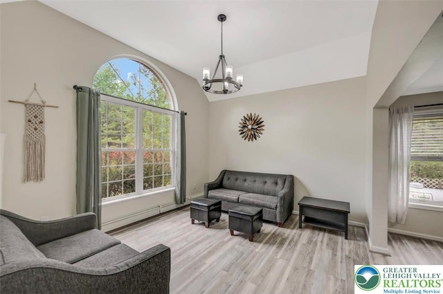 5117 Hounds Ear Rd, Coolbaugh Twp, PA 18466 - living area featuring a chandelier, light wood-style flooring, and lofted ceiling
