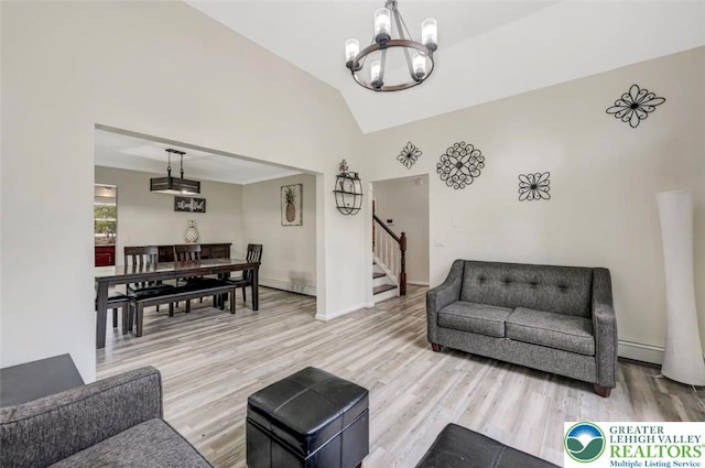 5117 Hounds Ear Rd, Coolbaugh Twp, PA 18466 - living area with a chandelier, stairway, light wood finished floors, lofted ceiling, and a baseboard heating unit