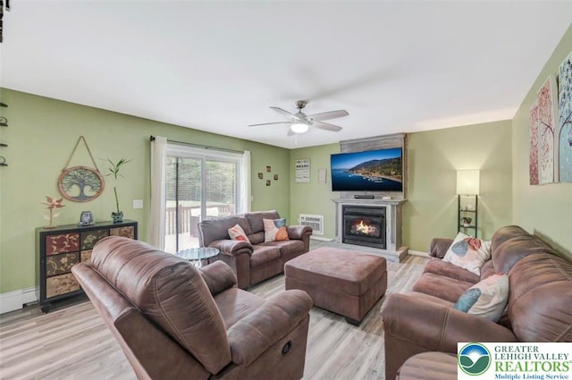 5117 Hounds Ear Rd, Coolbaugh Twp, PA 18466 - living area with light wood-type flooring, ceiling fan, and a glass covered fireplace