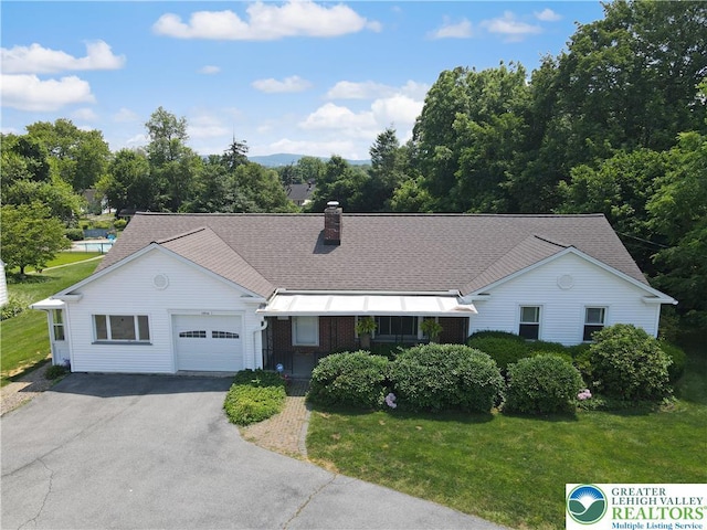 2930 Green Pond, Palmer Twp, PA 18045 - ranch-style house featuring an attached garage, asphalt driveway, a front yard, and a chimney