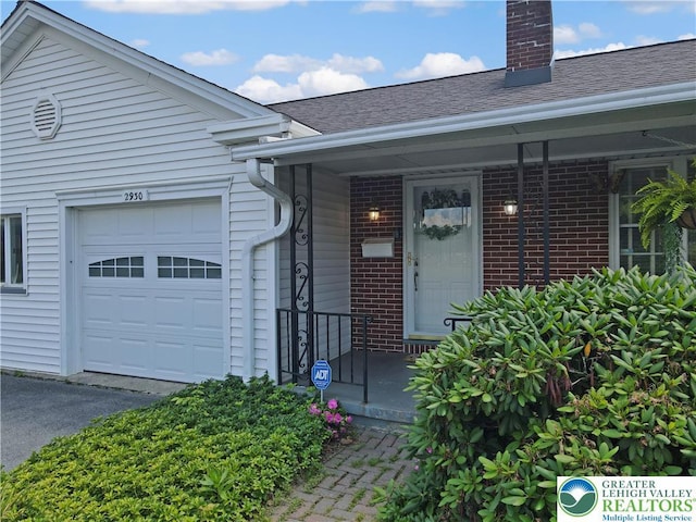 2930 Green Pond, Palmer Twp, PA 18045 - property entrance with brick siding, a shingled roof, a chimney, and a garage